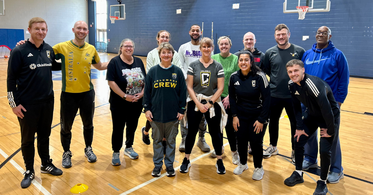 group of teachers with soccer professionals